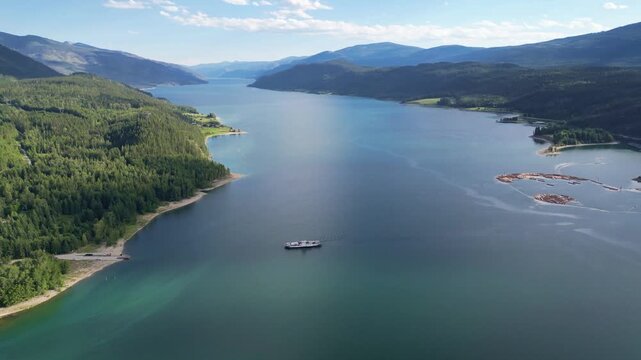 4K aerial drone footage of the Needles Ferry river crossing at lake arrow in British Columbia Canada.