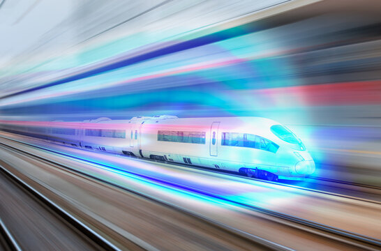 Blue high speed train runs on rail tracks - The train is going too fast as a result the air pressure is causing too much heat at the front