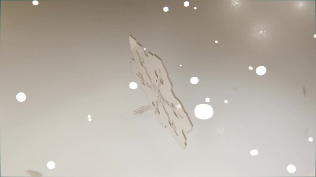 Rotating snowflake crystal drifting on play in studio, revealing symmetry with bokeh fragments
