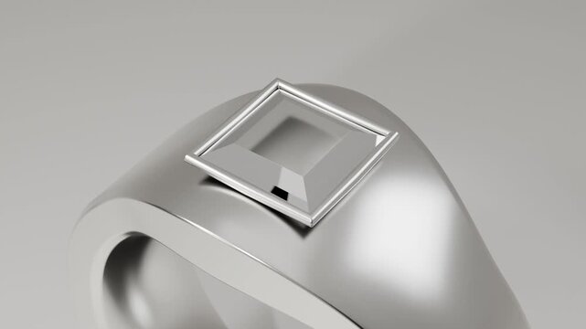 Pulling back camera revealing metal ring on gray backdrop to showcase square gem and thin frame