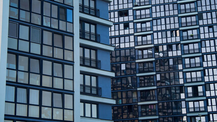 Obraz premium Modern residential building facade with geometric windows pattern architecture abstract