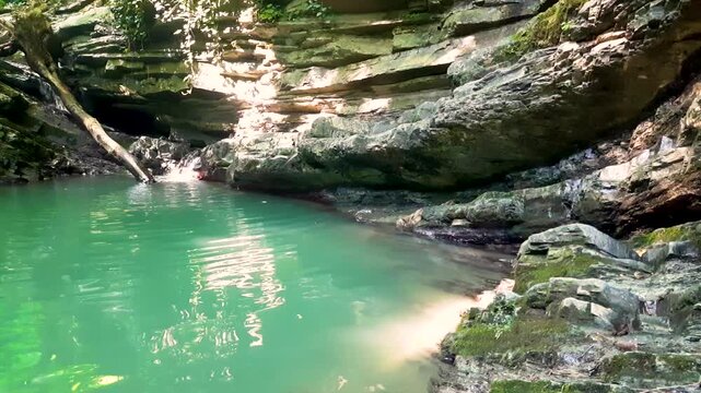 Waterfall in the mountains on a summer day for background, peace and relaxation.