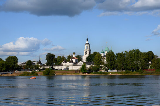 The walls, bell tower and domes of the church of the Tolga Monastery on the banks of the Volga River, and a lot of its visitors