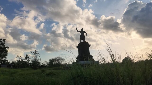 Scenic Rural Road in Bali with Traditional Penjor Decorations and Rice Fields