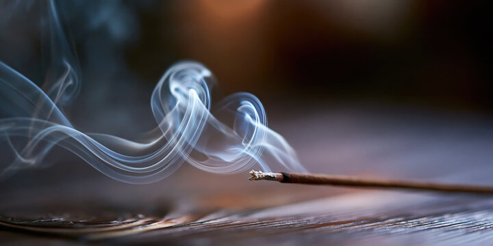 Close-up of incense stick burning with swirling smoke