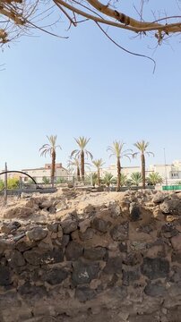 Ancient ruins at the historic othman well, also known as bir rumah, in a palm oasis.