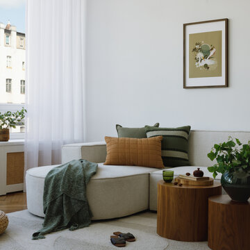 Inviting Modern Living Room Interior with Neutral Decor and Green Accents, Sofa with Comfort Pillows and Plant