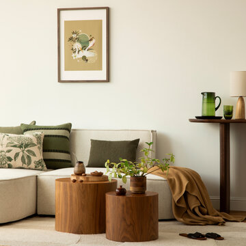 Minimalist living room interior with L-shaped sofa, wooden end tables, green accents, and natural light