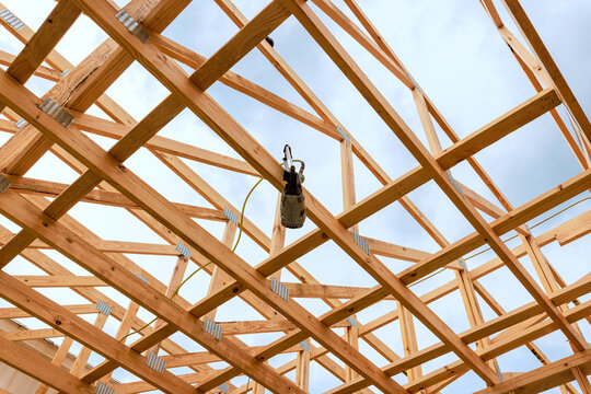 Construction workers build wooden structure timber framing wood beams building site