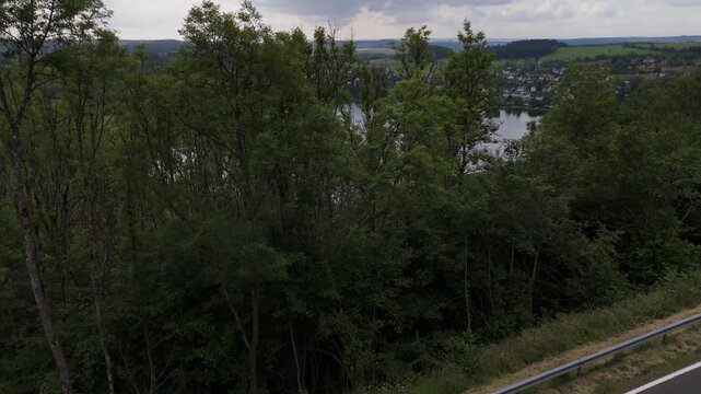 Upward Reveal Shot of Weinfelder Maar Volcanic Lake Germany