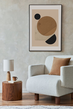 Stylish composition of modern living room interior with structure painting , beige armchair, piece of wood as coffee table and personal accessories. Creative wall, carpet on the floor. Template.