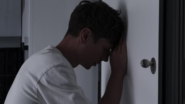 Obsessive checking and OCD symptoms concept with anxious man repeatedly looking through door peephole, fear, compulsive behavior and stress, close up