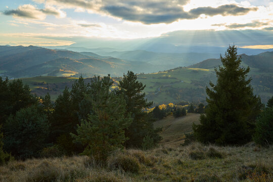 Wide angle landscape of autumn Pieniny mountains with dramatic sunbeams over a valley.