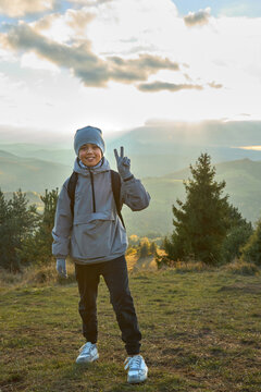 Happy young boy hiking in the autumn mountains. Active family li