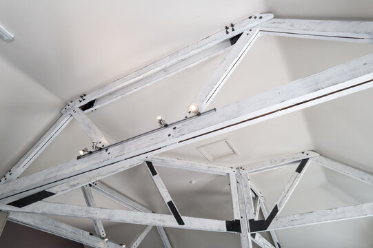 Interior restaurant ceiling view showing newly installed support frames which helps holding up the ceiling of an old property in the UK. LED spotlights have been installed on the beams.