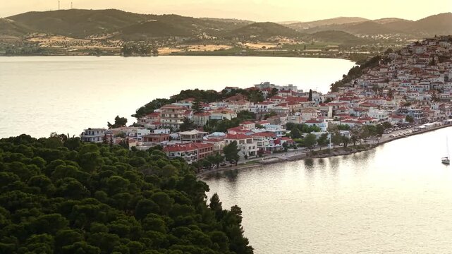 Aerial Establishing Shot of Ermioni Town and Bourtzi Pine Forest at Sunset. Argolis, Greek Peninsula