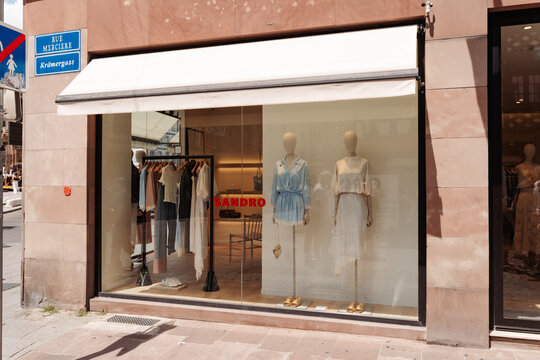 STRASBOURG, FRANCE - JULY 1, 2026 : Chic Fashion Boutique Sandro Storefront With Mannequin Window Display and Summer Dresses
