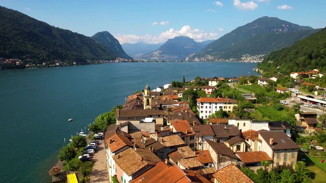 Cinematic Dolly Zoom Pull Back Drone Shot Brusino Arsizio Colorful Village Lake Lugano Switzerland Iconic Lakeside Architecture Alpine Mountain Backdrop Authentic Slow Living 4K Travel Footage