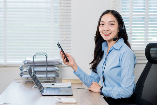 A businesswoman wearing headphones is a customer service representative.