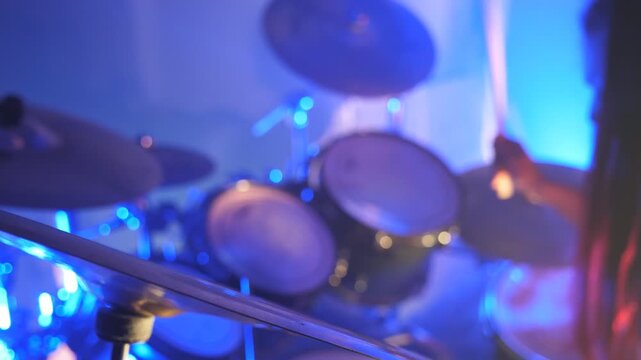Unrecognizable professional drummer playing on the drum by wooden sticks during rock concert. Music drums set. Close up Slow motion