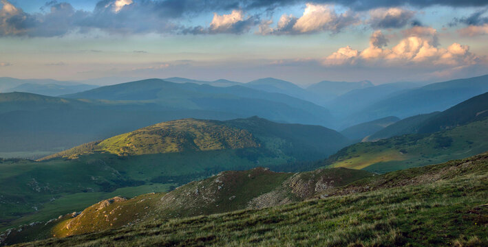view on hills and carpathian mountains at the evening under cloudy sky summit in Romania
