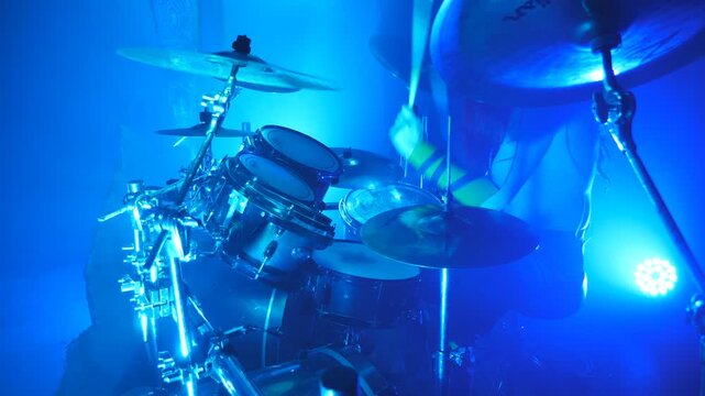 Professional drummer playing on the drum by wooden sticks during rock concert. Music drums set. Close up Slow motion
