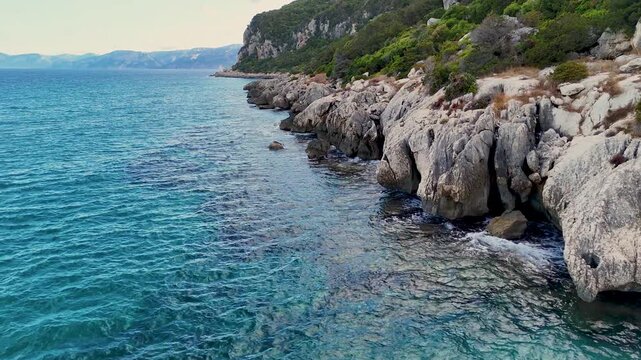 Vast Blue Ocean and Rocky Coastline Under Clear Sky. Holiday in Sardinia.