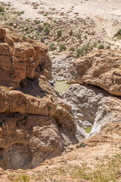 Looking down on two small pools of water near Nahal Rahaf-Rahaf Stream in the Judean Desert in Israel.
