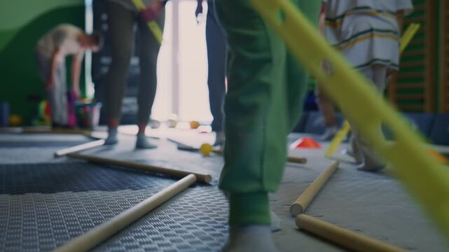 Young children engage in active play during a kids fitness session in a gym. Kids develop motor skills and coordination while participating in a fun exercise game.