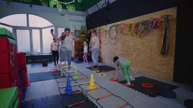 Children engage in a fun and dynamic fitness training session, navigating various obstacles and equipment.