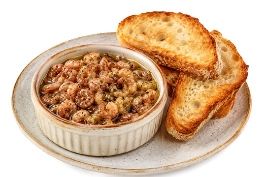 Potted shrimps, small brown shrimps preserved in spiced butter, served in a ramekin with toast, full serving visible