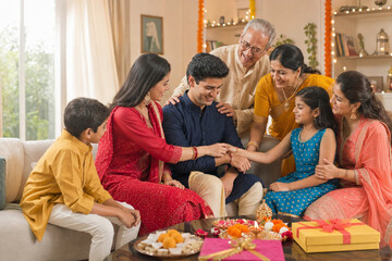 Fototapeta premium Indian family celebrating Raksha Bandhan together at home