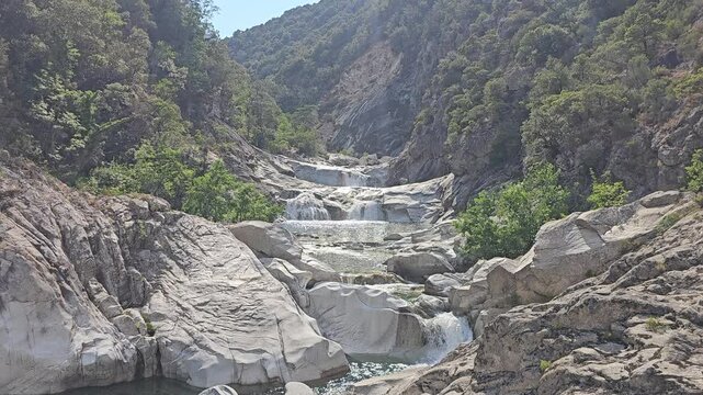 Static high-angle shot of the beautiful cascading natural pools of Chisa in Corsica.