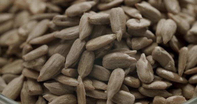 Healthy organic peeled sunflower seeds rotating. Raw shelled sunflower seeds rotating slowly in a detailed macro view, showcasing the texture and shape of the healthy edible kernels