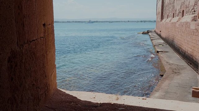 From a stone window, you can see the multi-coloured Mediterranean Sea, its gentle waves lapping against the Sicilian coastline