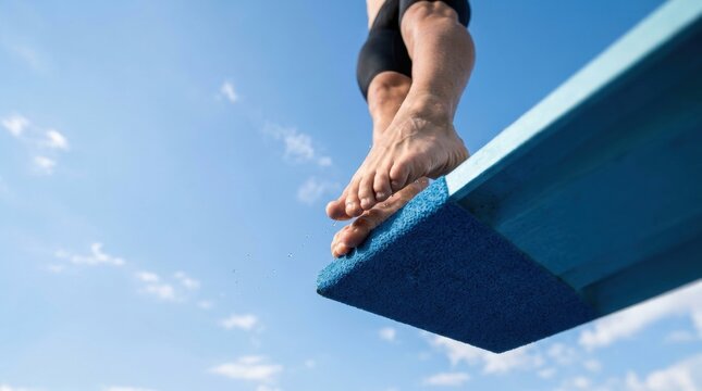 Divers toes leaving springboard, human foot on diving board