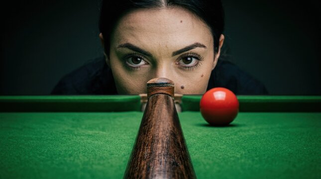 Female snooker players eye focused, woman player observes cue ball on pool table