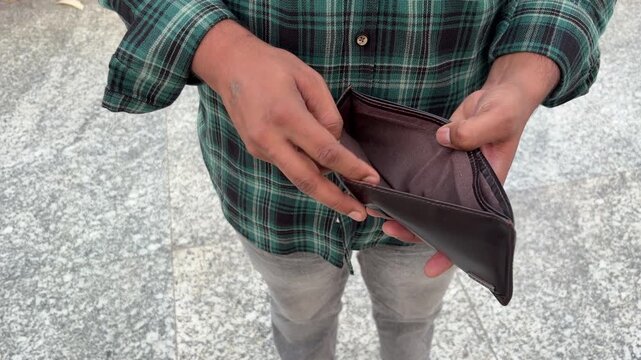 Close up shot of an Indian man showing his empty wallet, male hands holding wallet, No money, finance and investment concept