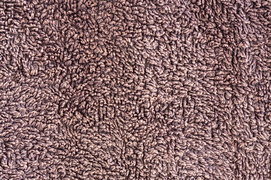 Close-up of brown terry cloth towel texture background