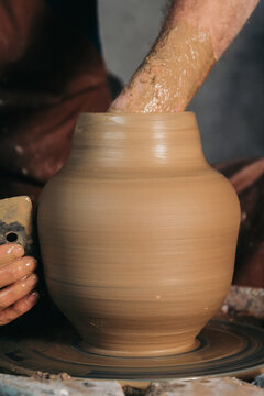 Potter Shaping Clay Vase on Wheel