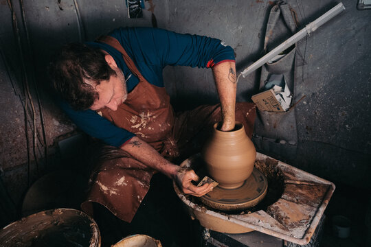Potter Shaping Clay Vase on Wheel