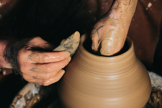 Potter Shaping Clay Vase on Wheel