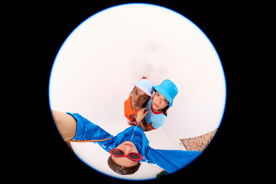 Friends Looking Into Fisheye Lens

