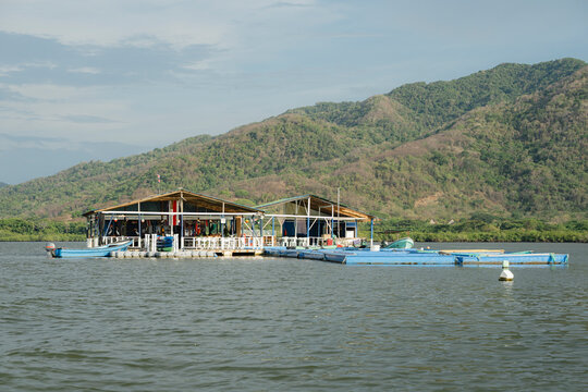 Floating houses on a lagoon with aquaculture activity