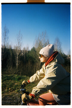 Cyclist rides on a sunny day in a forest with a clear blue sky