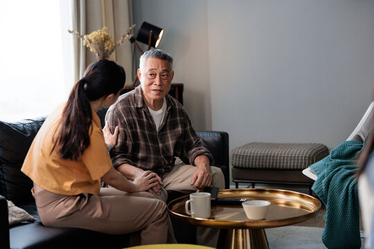 Daughter comforting her old father during a conversation