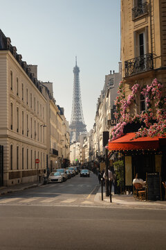 Eiffel Tower viewed from a historic Paris street with a flower cafe
