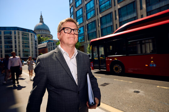 Businessman walks along the street in central London