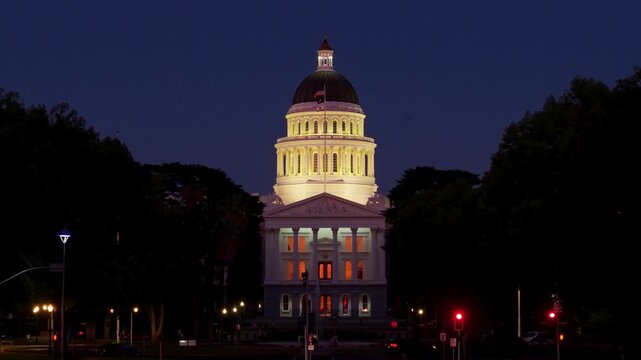 Aerial shots show the west side of the California State Capitol at night with the annex construction visible to the east.