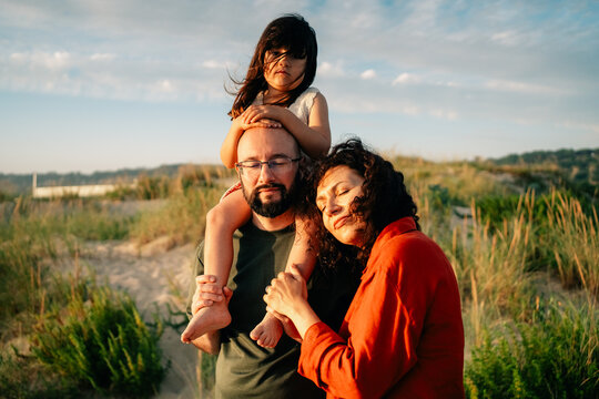Family Enjoys Time Together at the Beach During Sunset